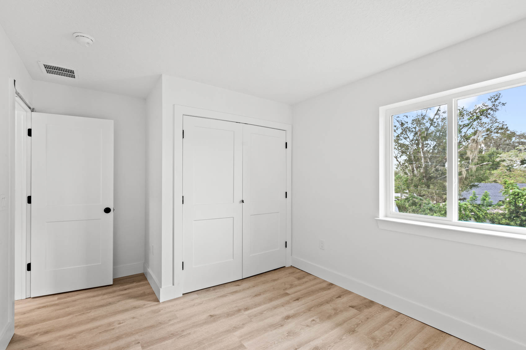 bedroom with white walls and window